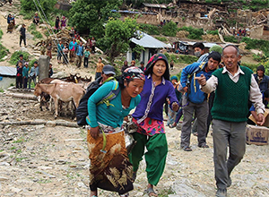 Villagers run toward the helicopter in a remote village outside of Gorkha, Nepal. 