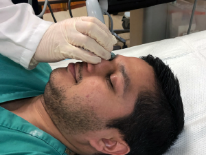 Figure 5: Stabilize your scanning hand by placing your pinky finger on the bridge of the patient’s nose.