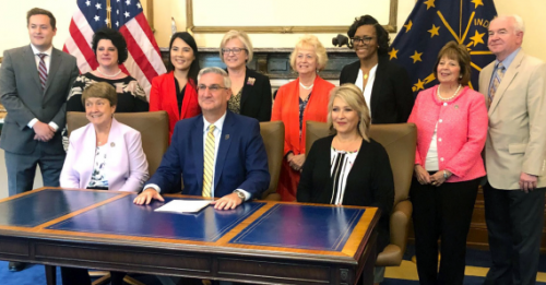 Dr. Kimberly Chernoby (back row, third from left) attended the signing ceremony for a law protecting pregnant minors that started as a resolution she brought to her state medical association.