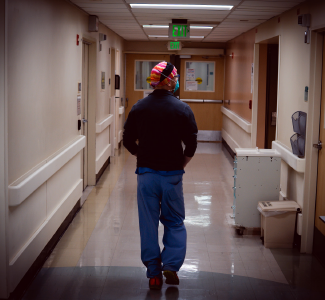 Dr. Erik Anderson walks down a hospital hallway.