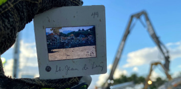 Dr. Benjamin Abo holds up a photo slide, one of many mementos that his team recovered from the site.